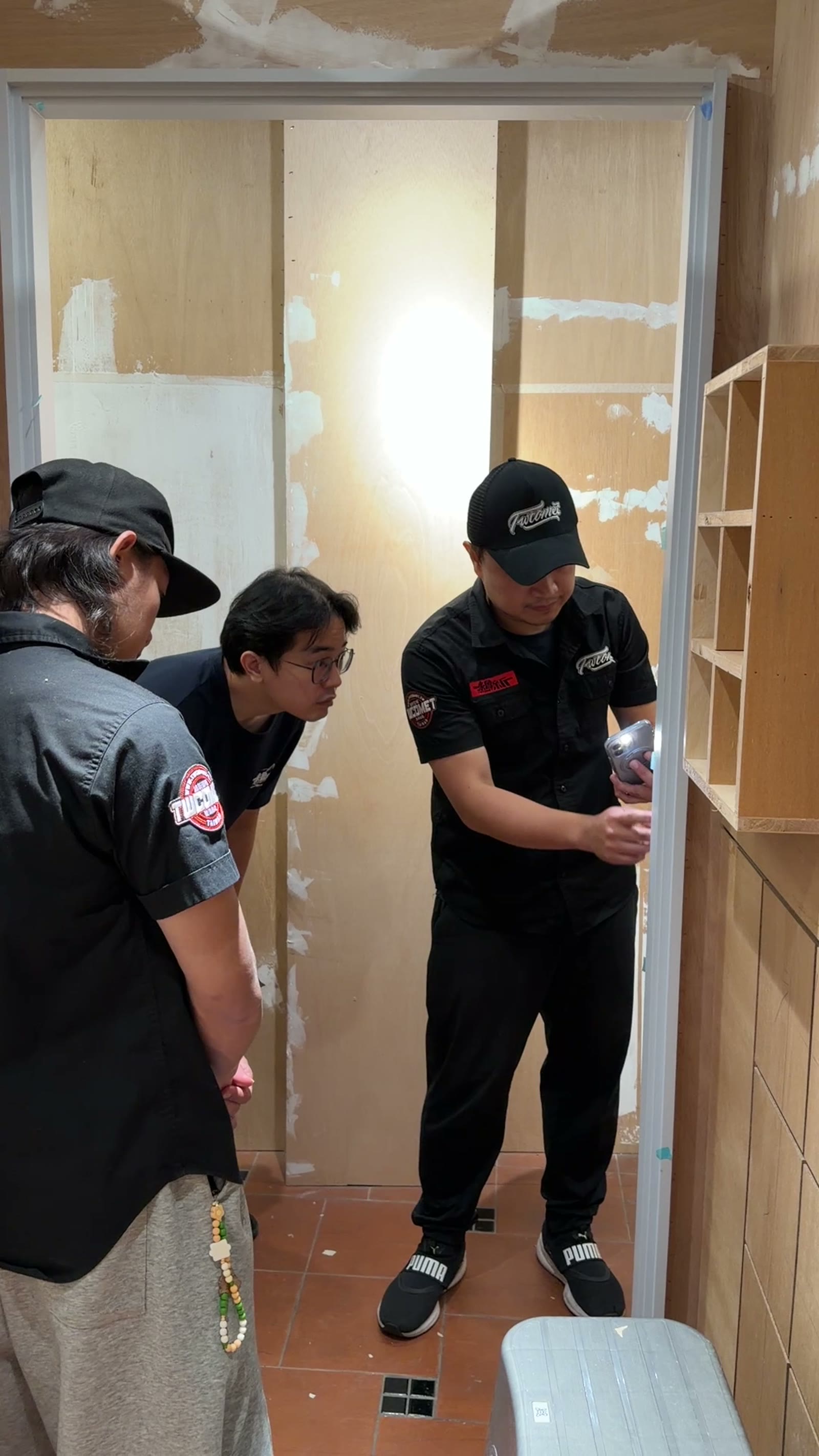 Instructor guiding a student at a door frame